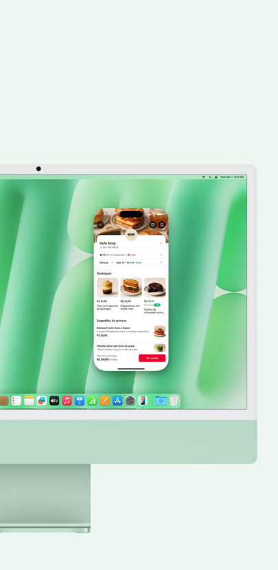 Um iMac verde demonstrando o uso do Espelhamento do iPhone e do app Mensagens na tela.