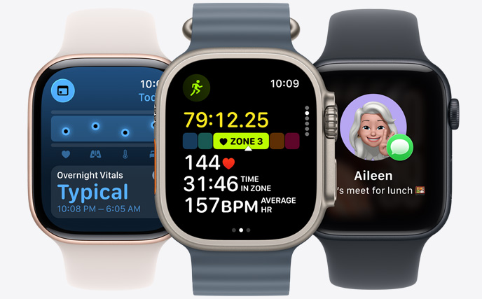 Three Apple Watch models, centre in Natural colour with Black strap, face shows run in progress with heart rate stats, right in Jet Black with Aquamarine strap, face shows Vitals, left in Starlight with Tangerine strap, face with Genmoji