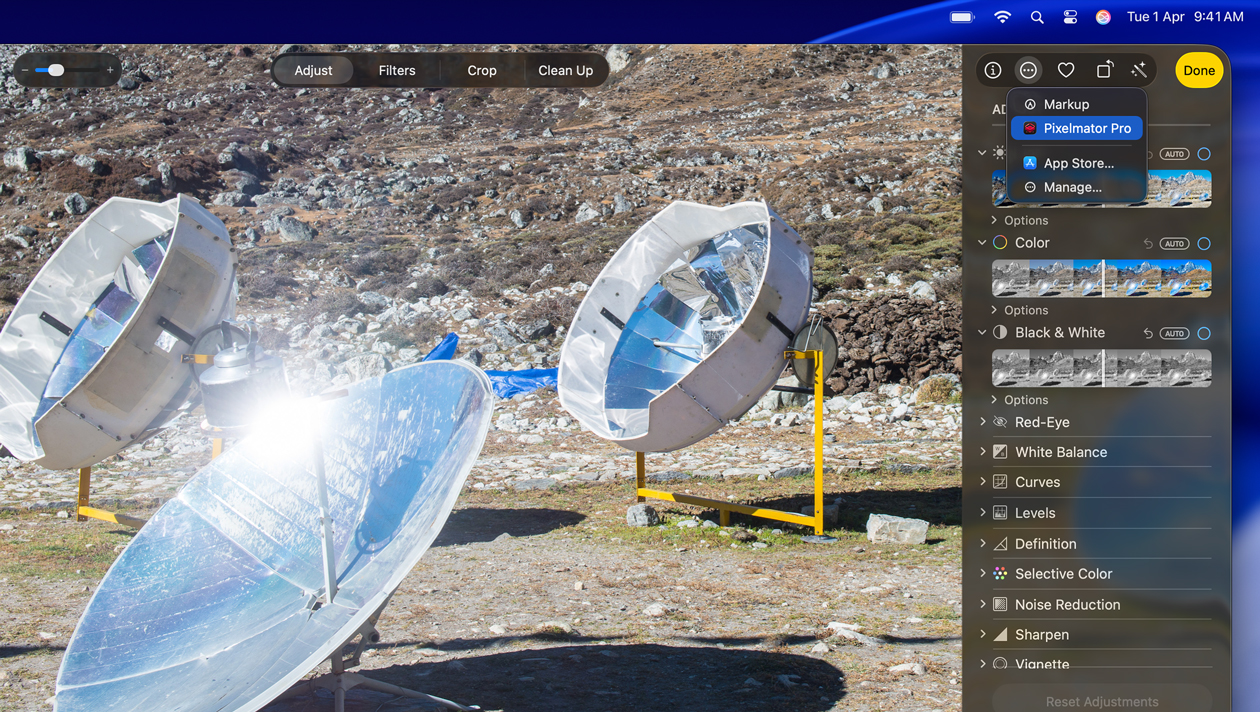 MacBook Pro 16″ screen, photo of three silver space telescopes on ground, image-editing tools