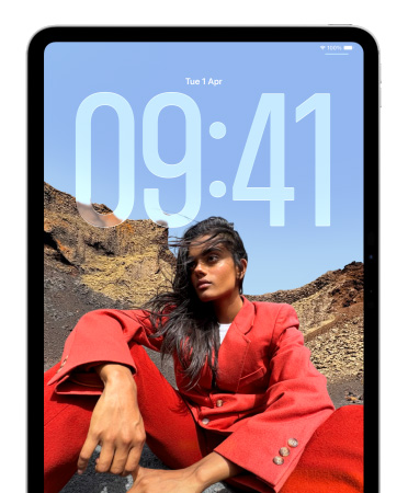 iPad showing Lock Screen where large numerals for the time appear behind the picture of a person sitting