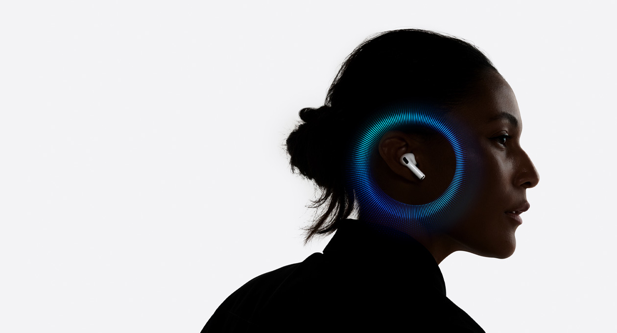 A person wearing AirPods Pro 3, pulsating waves around their ear