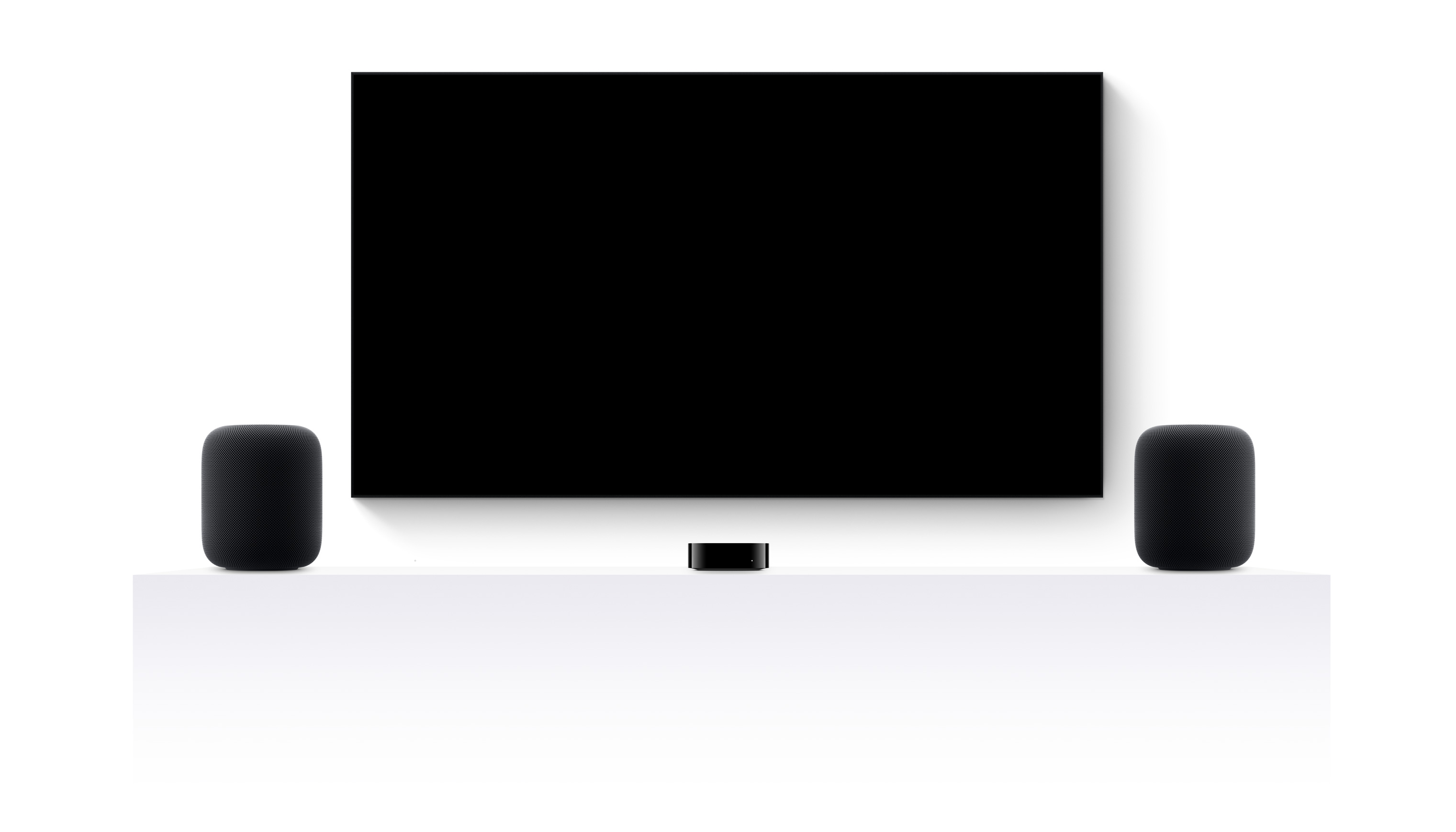 Apple TV 4k, two HomePods, and a flatscreen television showing Jurassic World Rebirth