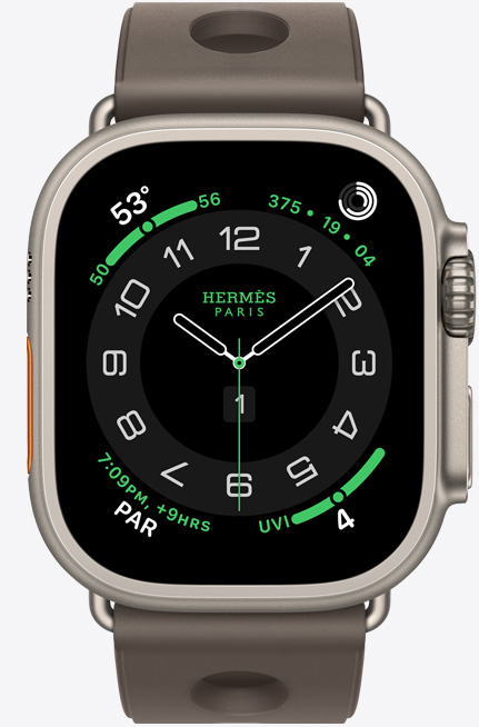 Apple Watch Hermès Ultra 3, titanium case, natural color, Hermès Circulaire watch face, complications: weather, activity rings, PAR, UV index, right side exterior, Digital Crown, microphone, raised side button, Scub'H Diving band, gris titane color