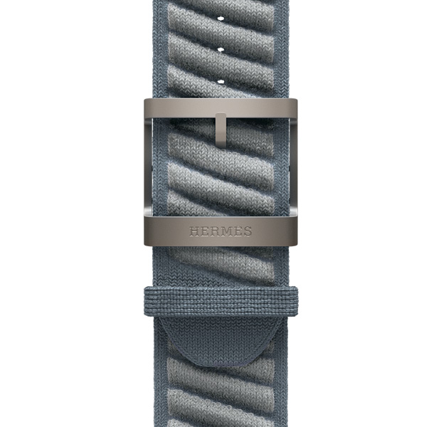 Apple Watch Hermès Ultra 3 En Mer strap, bleu gris/bleu glacier colour (blue grey with light grey diagonal textured stripes), knit polyamide yarn material, adjustment holes centred, natural colour titanium buckle engraved with Hermès