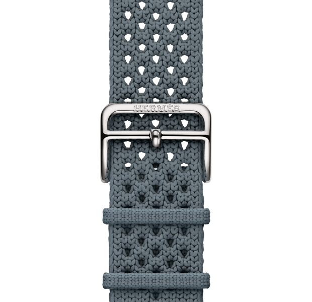 Apple Watch Hermès Series 11 Néo Tricot strap, bleu gris colour (blue grey), knit polyamide yarn material, adjustment holes centred, silver colour buckle closure engraved with Hermès