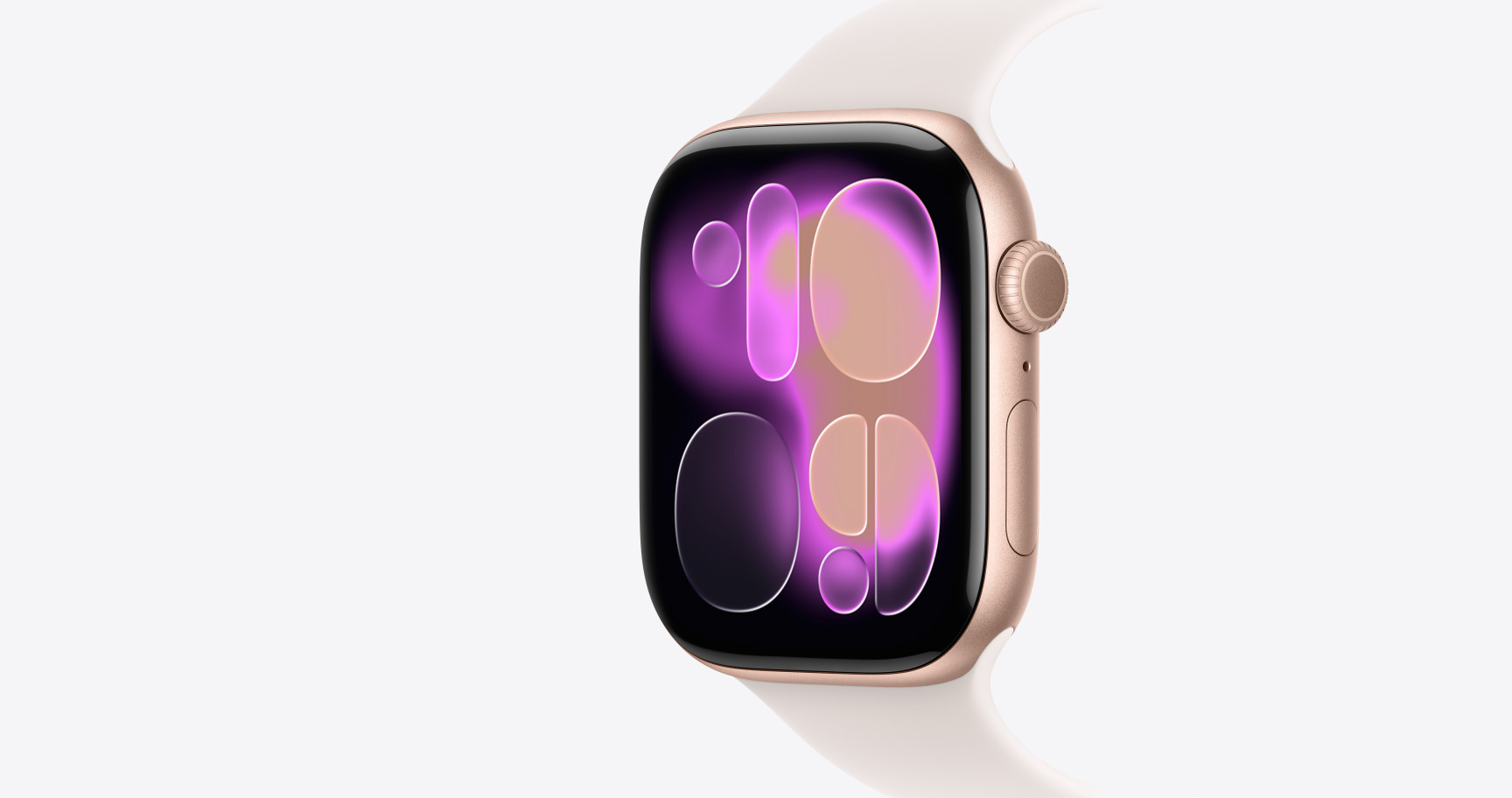 Apple Watch Series 11，展示玫瑰金色鋁金屬錶殼，搭配淡胭粉色運動型錶帶，螢幕顯示流動錶面，機身右側展示數位錶冠、麥克風、側邊按鈕