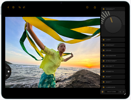 iPad Air, front exterior, editing photo of a person holding green and yellow fabric against a sunset beach backdrop, with editing tools visible on the right side