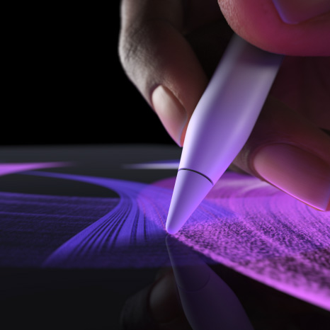 Apple Pencil Pro, side exterior, white colour, hand holding pencil drawing a vibrant blue brush line