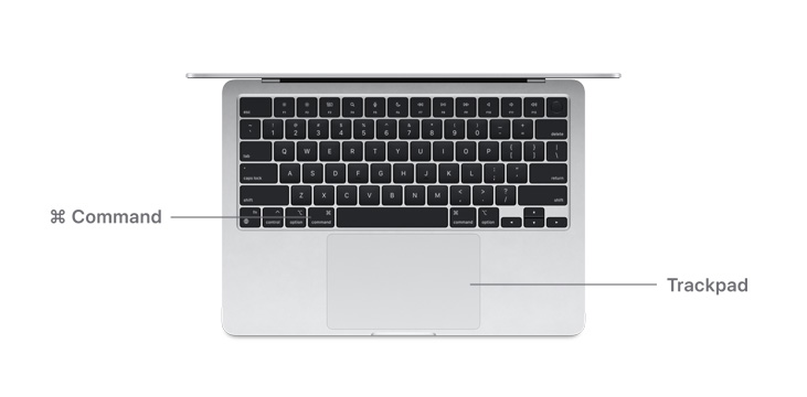 Desk view of MacBook Air M4 Command key button and trackpad.
