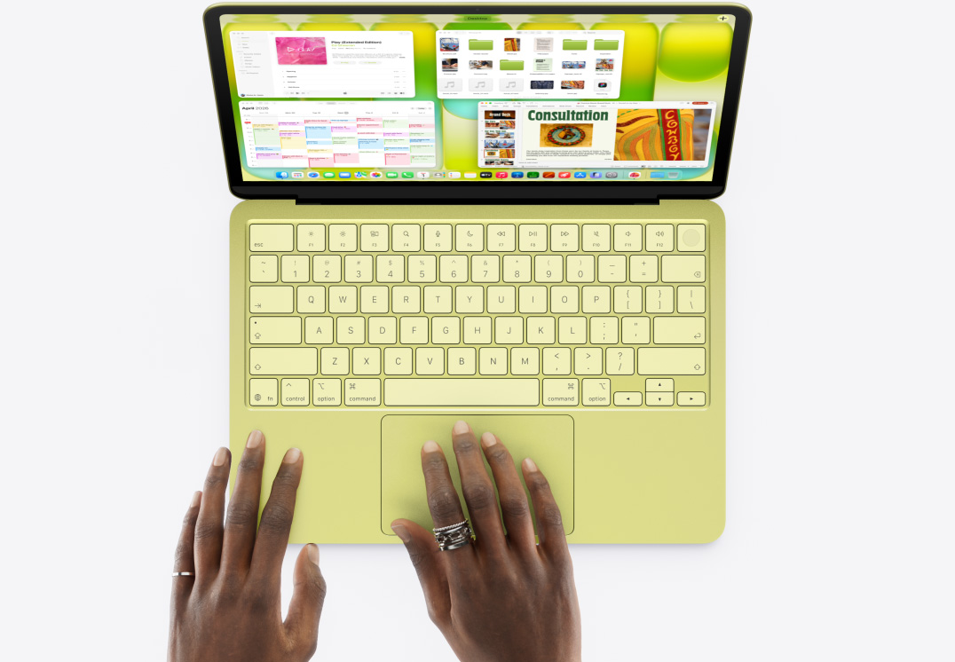 MacBook Neo, citrus colour, a person's hands typing and using trackpad, screen shows rapid montage of various actions including preparing presentation, managing files, visiting website and listening to music, ending with using Mission Control to view all open windows