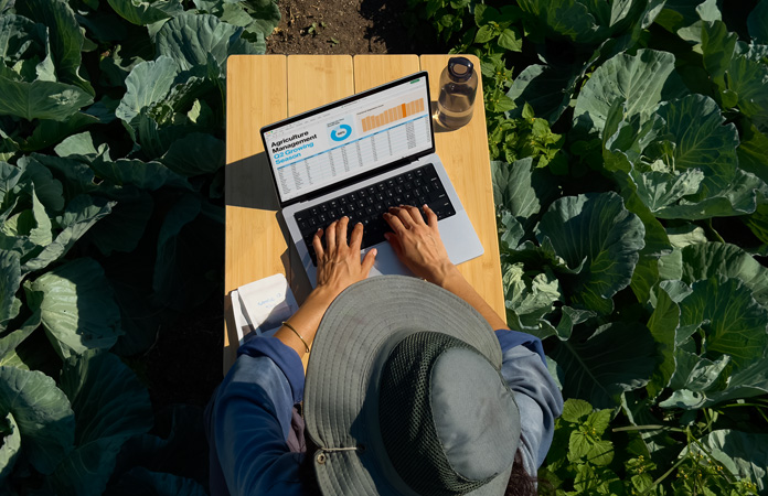 Človek používa v exteriéri MacBook Pro s voliteľným sklom s nanotextúrou a demonštruje redukciu odleskov