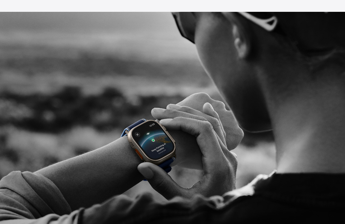 A person uses two-way satellite communication on Apple Watch Ultra 3 while hiking